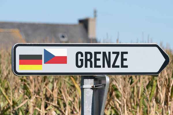 A sign points to the border between Germany and the Czech Republic