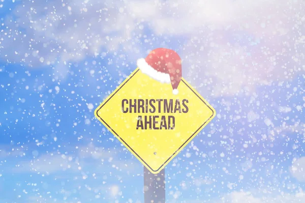 Winter, snow and a sign with the phrase Christmas Ahead