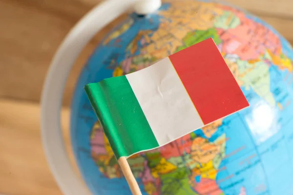 Flag of Italy and globe in the background