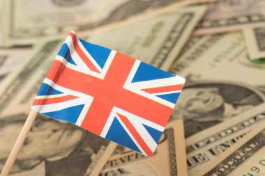 Flag of Great Britain and dollar bills in the background