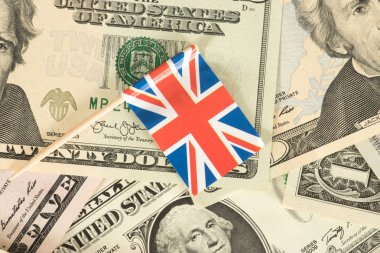 Flag of Great Britain and dollar bills in the background