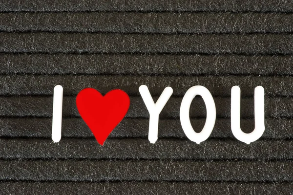 A blackboard, heart and slogan I love you