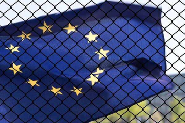Flag of European Union EU and a fence on the border