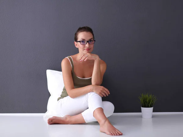 Attraktive kaukasische Mädchen sitzt auf dem Boden mit Tasse und Tablette in der Nähe der Wand — Stockfoto