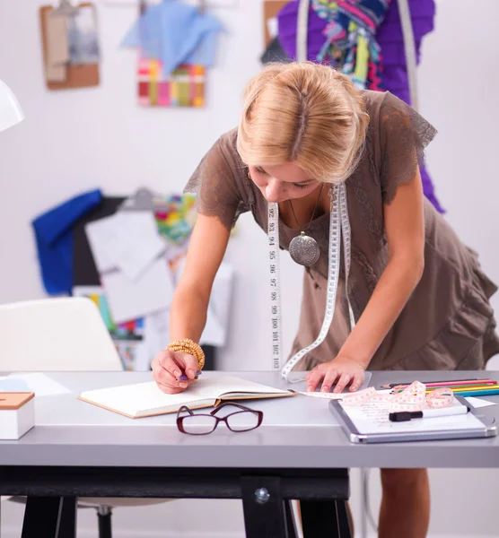 Junge Modedesignerin arbeitet im Atelier. — Stockfoto