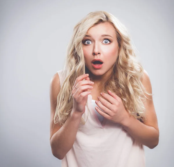 Junge emotionale Frau, isoliert auf grauem Hintergrund — Stockfoto