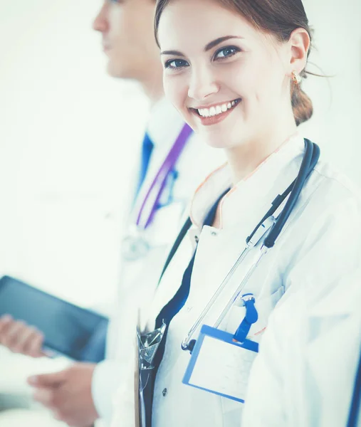 Attractive female doctor in front of medical group — Stock Photo, Image