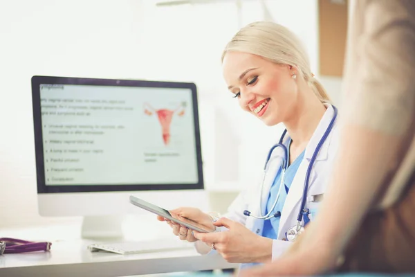 Dokter en patiënt bespreken iets terwijl ze aan tafel zitten. Geneeskunde en gezondheidszorg. Dokter en patiënt — Stockfoto