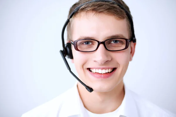 Portrait of young man smiling sitting on gray background. Portrait of young man — Stock Photo, Image