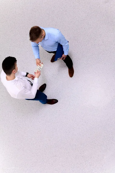 Businessmen standing and holding money in hand — Stock Photo, Image