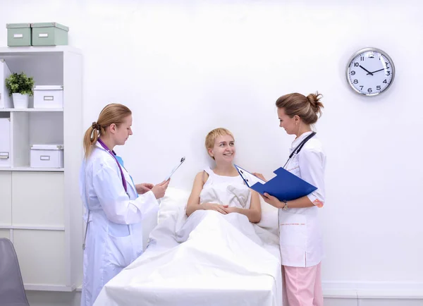 Young woman doctor standing at hospital with medical stethoscope — Stock Photo, Image