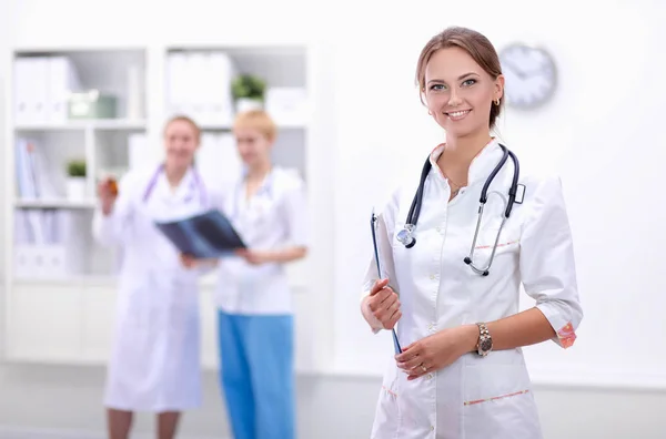 Young woman doctor standing at hospital with medical stethoscope — Stock Photo, Image