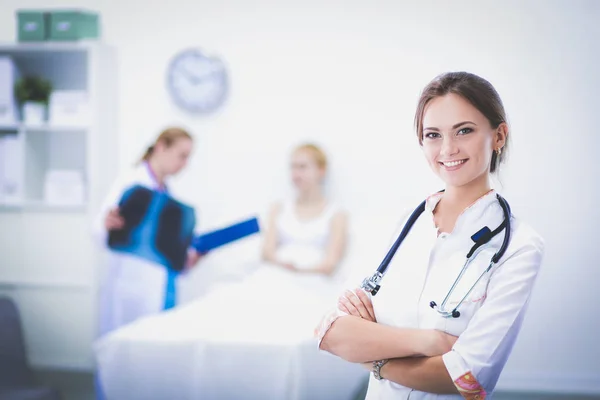 Young woman doctor standing at hospital with medical stethoscope — Stock Photo, Image