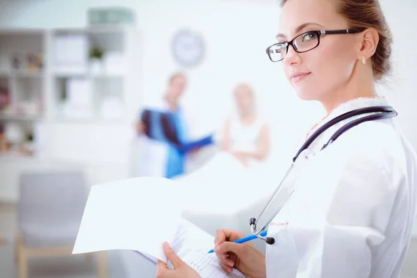 Young woman doctor standing at hospital with medical stethoscope — Stock Photo, Image