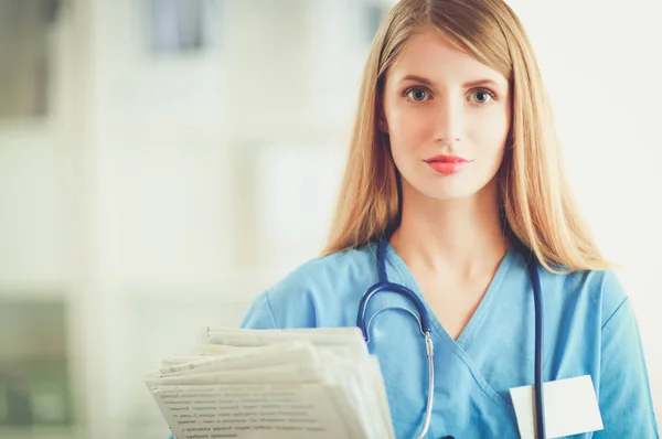 Portrait of woman doctor with folder at hospital corridor — Stock Photo, Image