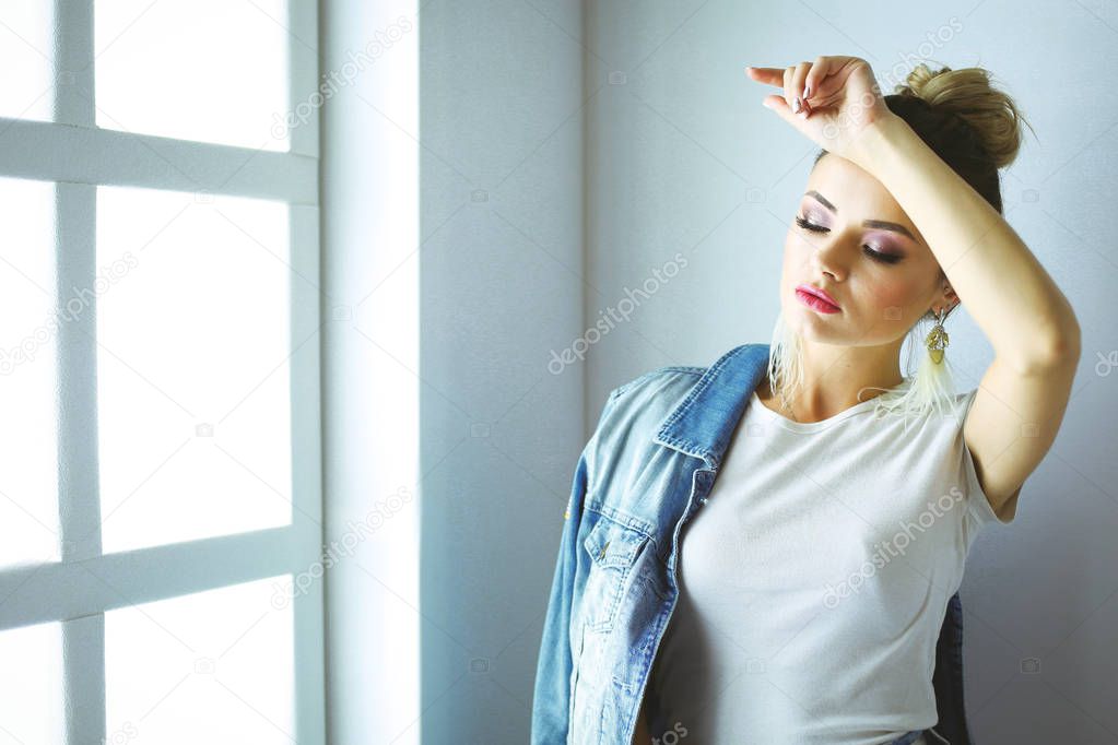 Beautiful woman portrait standing near window.Isolated on white background