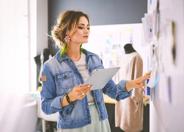 Fashion designer woman working on her designs in the studio — Stock Photo, Image