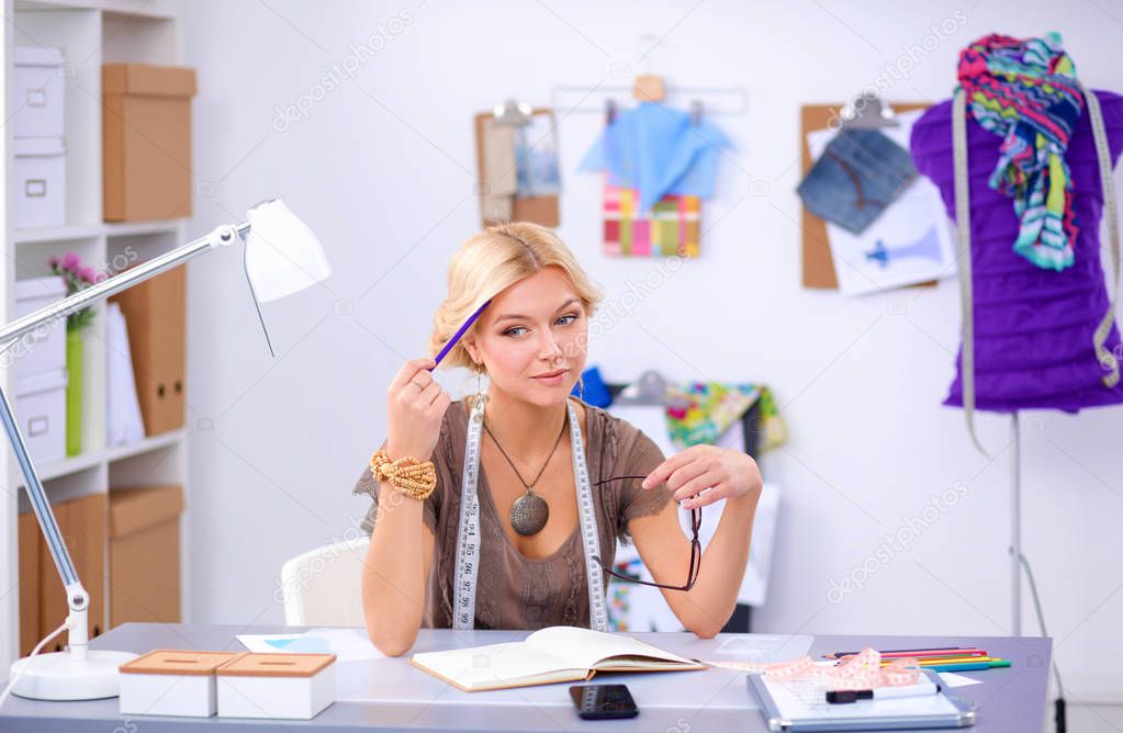 Young woman fashion designer working at studio.