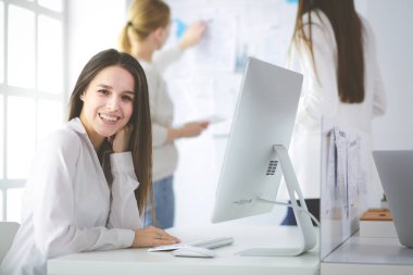 Ofiste dizüstü bilgisayarda çalışan çekici kadın. İş adamları