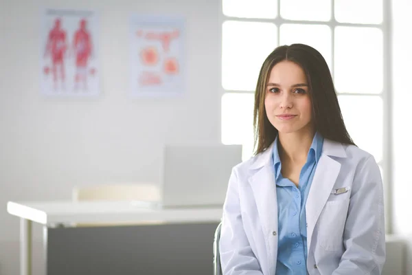 Female doctor using tablet computer in hospital lobby