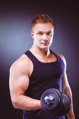 yakışıklı kaslı adam dumbell ile çalışma dışarı.