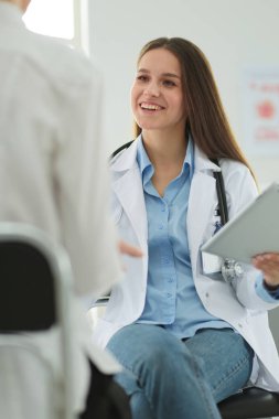 Doktor ve hasta masada otururken bir şey tartışıyorlar. İlaç ve sağlık hizmetleri kavramı