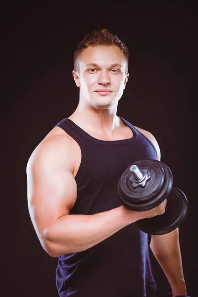 Handsome muscular man working out with dumbbells — Stock Photo, Image