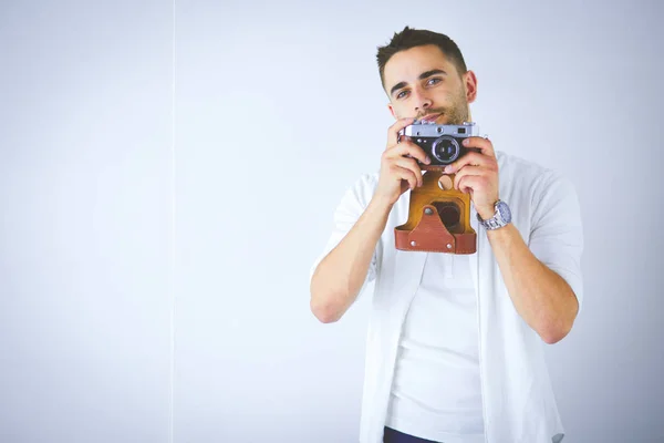 Young man with camera. Isolated over white background — Stock Photo, Image