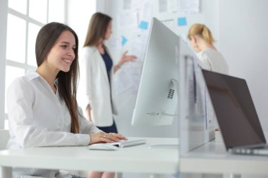 Ofiste dizüstü bilgisayarda çalışan çekici kadın. İş adamları