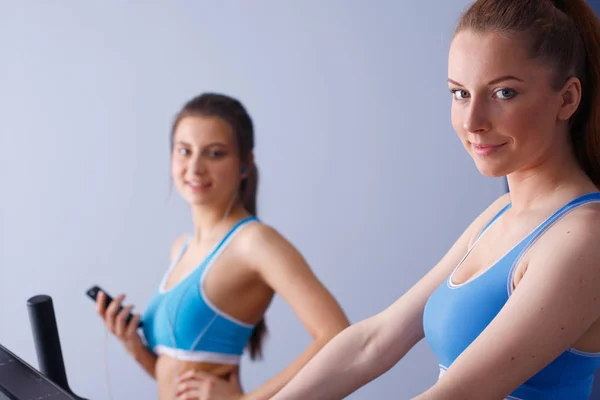 Group of people at the gym exercising on cross trainers. people at the gym