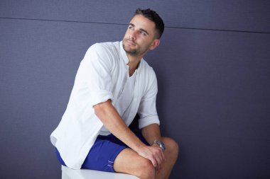 Genç iş adamı beyaz arka planda tek başına duruyor.