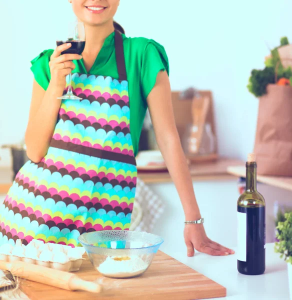 Smiling young woman in the kitchen, isolated on background — Stock Photo, Image