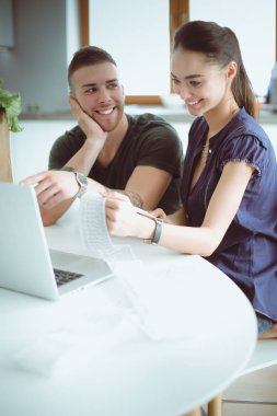 Çift evde mutfak içinde laptop ile onların fatura ödeme