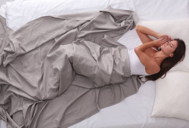 Evdeki yatakta uzanmış güzel esmer