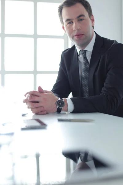 Portrait de jeune homme assis à son bureau dans le bureau. — Photo