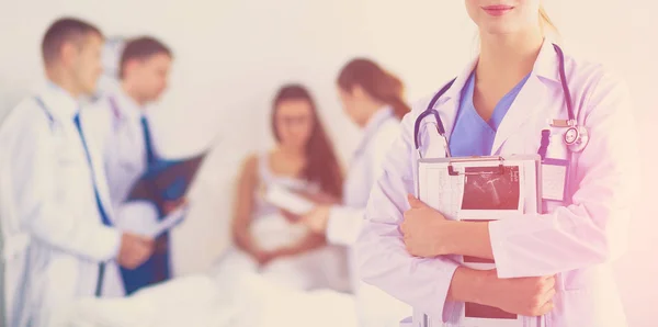 Woman doctor standing with stethoscope at hospital — Stock Photo, Image