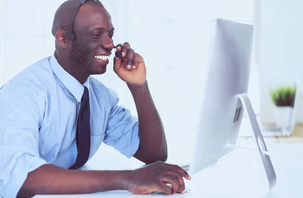 African american businessman on headset working on his laptop — Stock Photo, Image