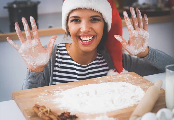 Happy young woman smiling happy having fun with Christmas preparations wearing Santa hat — Stock Photo, Image