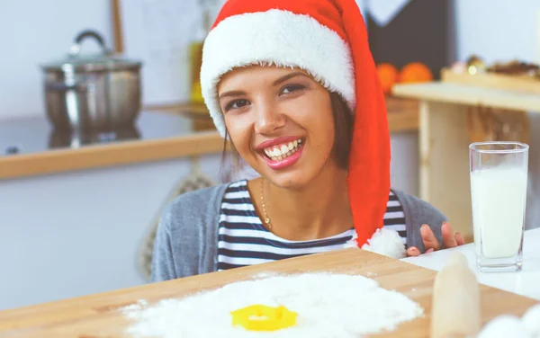 Happy young woman smiling happy having fun with Christmas preparations wearing Santa hat — Stock Photo, Image