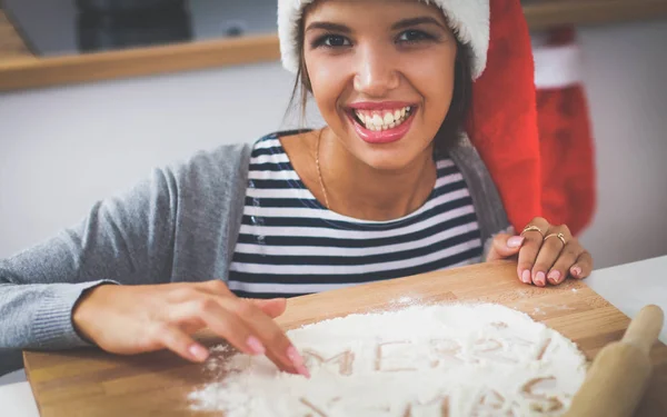 Happy young woman smiling happy having fun with Christmas preparations wearing Santa hat — Stock Photo, Image