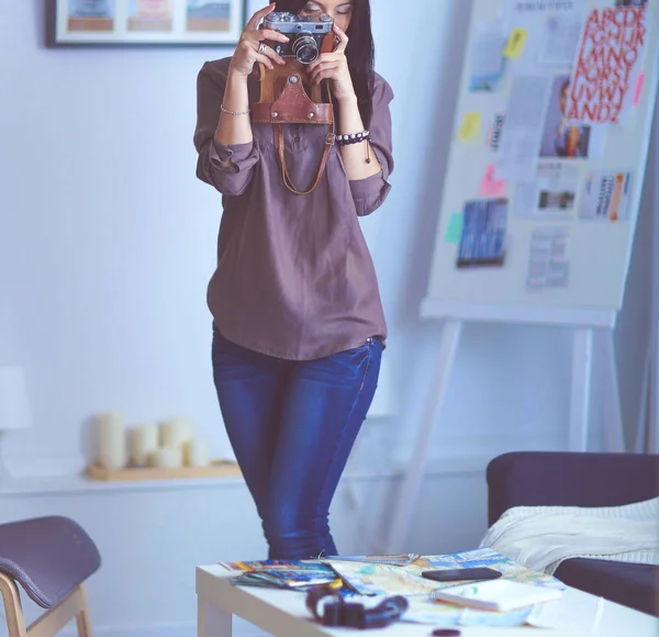 Female photographer sitting on the desk with laptop — Stock Photo, Image