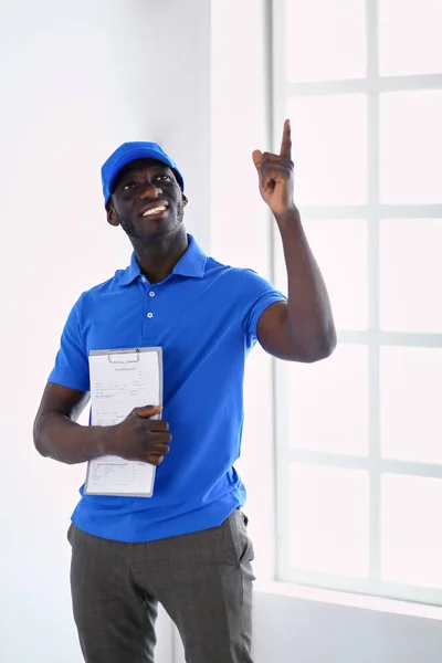 Retrato de un apuesto entregador feliz con carpeta —  Fotos de Stock