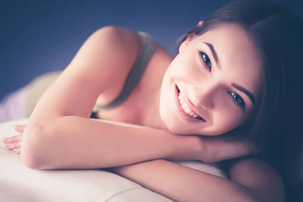 Beautiful young woman lying on the sofa — Stock Photo, Image