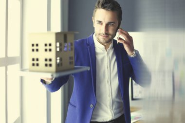 Ev minyatür Office el ayakta tutan işadamı.