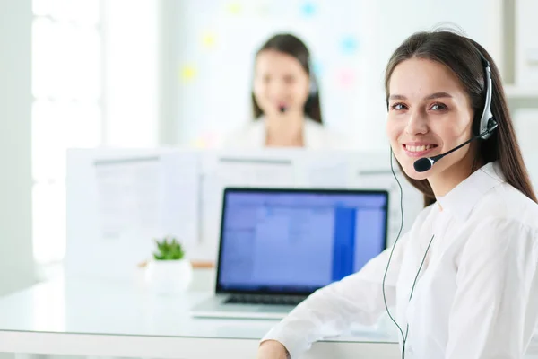 Smiling businesswoman or helpline operator with headset and computer at office — Stock Photo, Image