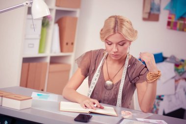 Stüdyoda çalışan genç kadın moda tasarımcısı..