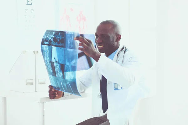 Portrait young african medical doctor holding patients x-ray — Stock Photo, Image