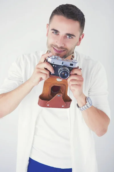 Young man with camera. Isolated over white background. — Stock Photo, Image