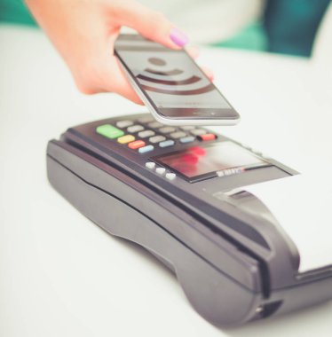 Müşteri ile smartphone Nfc teknolojisi kullanılarak dükkanda ödüyor. NFC teknolojisi. Müşteri ödeme