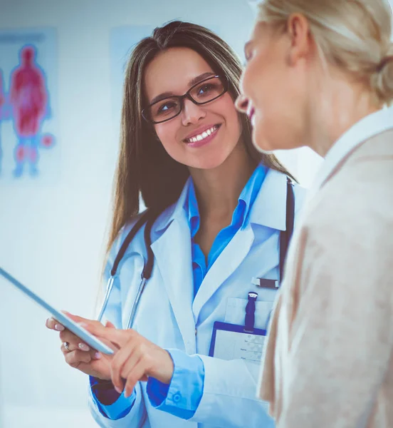 Doktorn och patienten diskuterar något när de sitter vid bordet. Medicin och hälsovård — Stockfoto